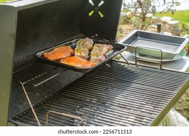 Meat is grilled on the charcoal grill in a griddle - Shutterstock ID 2256711513