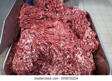 The Meat In The Grinder. The Meat Industry. Minced Meat Being Extruded From An Industrial Mincing Machine.