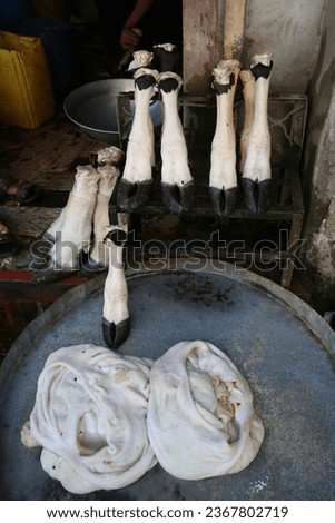 Meat, hooves, offal, beef on street market, traditional national bazaar in Peshawar, Pakistan. Pakistani traditional national food. Sale, trade, street shop in Peshawar city, Pakistan. Offal meat