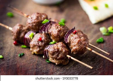 Meat kebab, beef balls on skewer with onions, avocado sauce guacamole, spring picnic