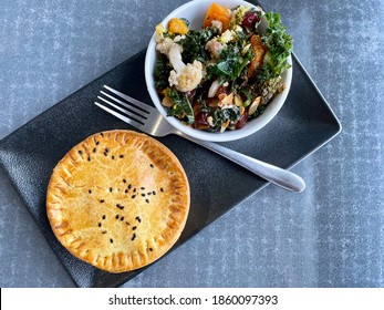 Meat Pie With Cauliflower And Kale Side Salad On A Square Plate