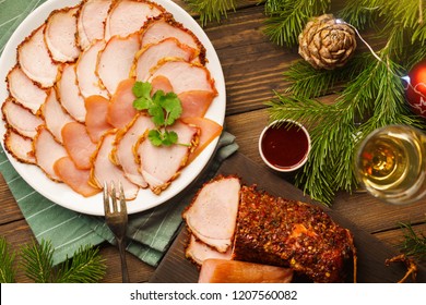 Meat Plate With Various Smoked Appetizers For A Christmas Dinner On Dark Wooden Table. Sweet And Spicy Sauce, Glass Of Champagne Or Wine. Overhead Shot.