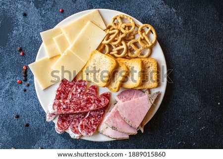 Similar – Image, Stock Photo Cheese Board with Ham, Cheese and a Knife