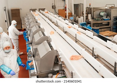 Meat Processing Plant.Industrial Equipment At A Meat Factory.Modern Poultry Processing Plant.People Working At A Chicken Factory - Stock Photo.Automated Production Line In Modern Food Factory.