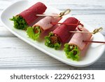 Meat rolls in plate on banquet table