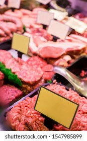 Meat And Sausages In A Butcher Shop. Stand. Showcase With Meat In Small Local Store. UK Food Supermarket.