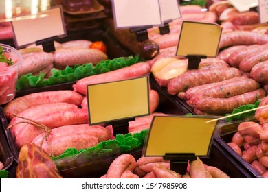 Meat And Sausages In A Butcher Shop. Stand. Showcase With Meat In Small Local Store. UK Food Supermarket.