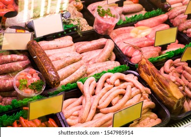 Meat And Sausages In A Butcher Shop. Stand. Showcase With Meat In Small Local Store. UK Food Supermarket.