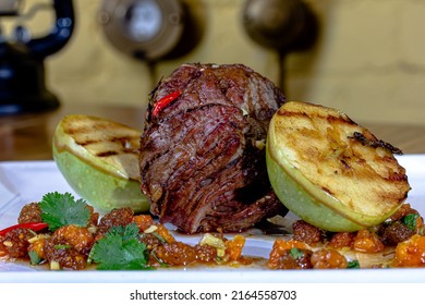 Meat Savory : Beef Fillet Mignon Grilled And Garnished With Baked Apples And Tomatoes On White Plate Isolated Over White Background