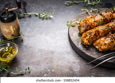 Meat skewers preparation with seasoning  on  dark rustic background, place for text
