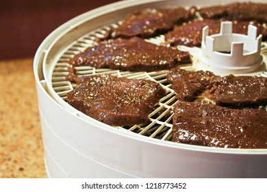 Meat Slices Laid Out On A Dehydrator To Be Made Into Deer Jerky