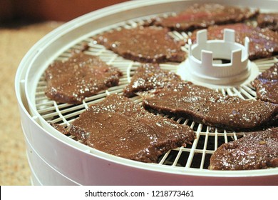 Meat Slices Laid Out On A Dehydrator To Be Made Into Deer Jerky