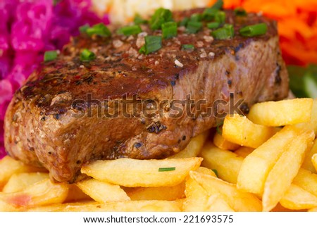 meat steak with french fries close up 