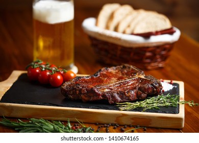 meat, steak or rib on a board, beer