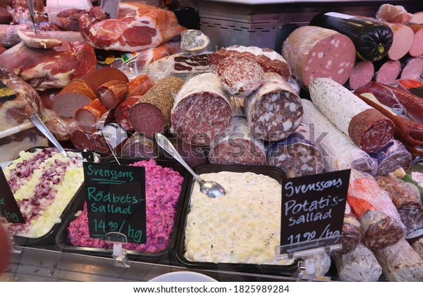 Meat\
store in Gothenburg Market Hall (Saluhallen), Sweden. Various\
smoked hams, bacons, sausages, salami and\
salads.
