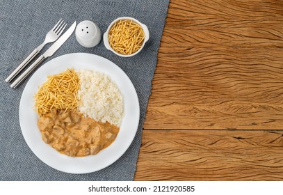 Meat strogonoff with rice and straw potato with copy space.