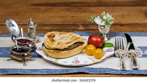 Meat and vegetable pie serving on the wooden table