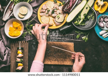 Similar – Image, Stock Photo Female hands making chicken skewers with vegetables for grilling