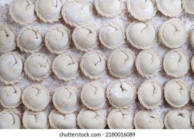 Meat or vegeterian dumplings, pelmeni on a wooden board. Russian national food. Close up top view. - Shutterstock ID 2180016089
