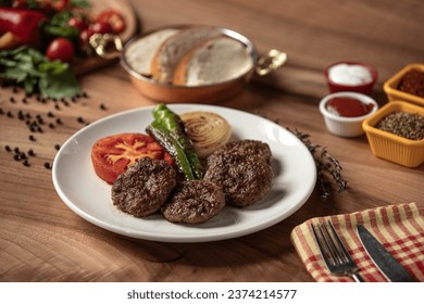 Meatball plate,
Roasted peppers, Roasted tomatoes, Roasted onions and meatballs plate, Barbecued meatballs,
Meatball plate on wooden table, grilled meatballs, Delicious composition - Powered by Shutterstock