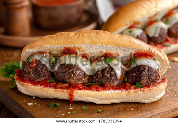 Meatball sandwich with tomato sauce and cheese on a\
hoagie roll