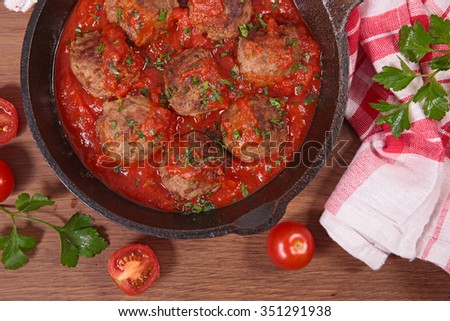 Similar – Image, Stock Photo Meatballs in tomato sauce on black tray. Above view of meat dish