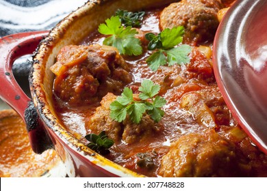 Meatballs Casserole In Red Iron Crock Pot.