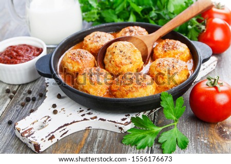 Similar – Image, Stock Photo Meatballs in tomato sauce on black tray. Above view of meat dish