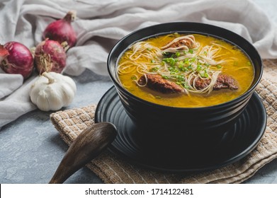 Meatballs and Noodles Soup topped with Spring Onions (Wide) - simply called Almondigas, is a hearty Filipino dish consisting of meatballs and misua.