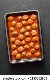 Meatballs With Tomato Sauce In Baking Dish Over Dark Stone Background. Top View, Flat Lay