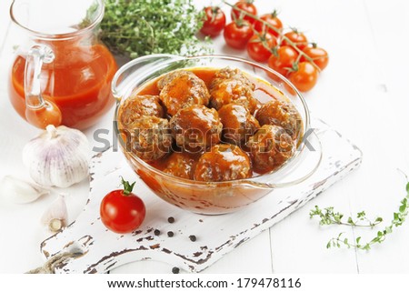 Similar – Image, Stock Photo Meatballs in tomato sauce on black tray. Above view of meat dish