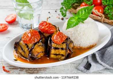 Meatballs wrapped in eggplant on a plate of rice. Traditional Turkish dish Islim Kebabi (Kürdan Kebabi)