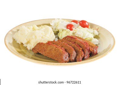 A Meatloaf Dinner On A White Background