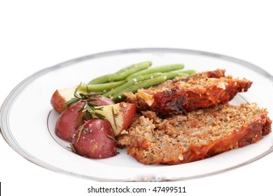 Meatloaf Dinner With Roasted Red Potatoes And Green Beans Isolated On White. Extreme Shallow DOF.