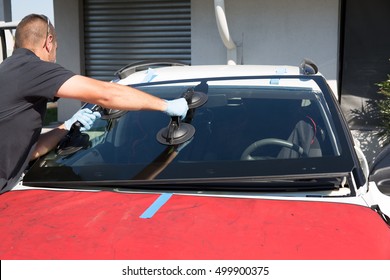 Mecanic Man Is Changing Windscreen On A Car