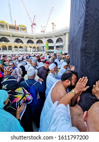 MECCA, SAUDI ARABIA - DECEMBER 10 2019: Crowd Of Pilgrims Trying To Kiss The Black Stone In The Corner Of The Holy Kaaba In Makkah If Fail They Also Kiss A Wall Of Kaaba.