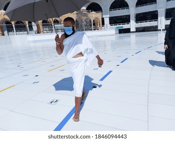 MECCA , SAUDI ARABIA , OCT/22/2020 - Pilgrims Circle The Kaaba At Masjid Al-Haram - Umrah Fewer Muslims People Socially Distanced Corona Virus Wearing Face Mask