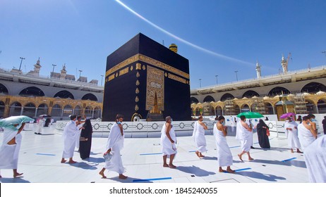 MECCA, SAUDI ARABIA , OCTOBER 22, 2020 - Pilgrims circle the Kaaba at Masjid al-Haram - umrah Fewer Muslims people Socially Distanced corona virus wearing face mask