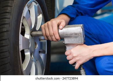 Mechanic adjusting the tire wheel at the repair garage - Powered by Shutterstock