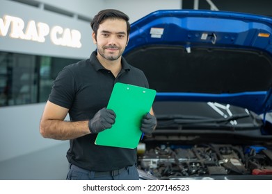 Mechanic Asian Man Close Up Using Checklist To Tuning Fixing Repairing Car Engine Automobile Vehicle Parts Using Tools Equipment In Workshop Garage Support Service In Overall Work Uniform