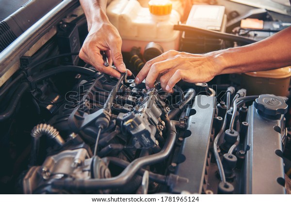 Mechanic Car Service in automobile garage auto\
car and vehicles service mechanical engineering. Automobile\
mechanic hands car repairs automotive technician workshop center.\
Services car engine\
machine