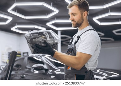 A mechanic is carefully inspecting a car headlight in a modern auto repair shop. The image captures the professional environment and attention to detail. - Powered by Shutterstock