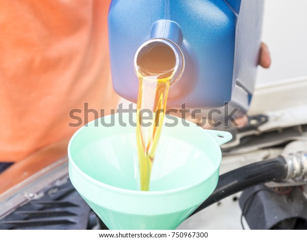 Mechanic change engine oil to preserve engine\
life,  maintenance\
concept