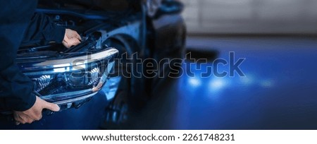 Mechanic changing car headlight in a workshop Сток-фото © 