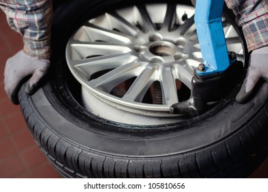 Mechanic changing  car tire closeup