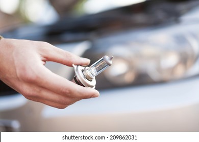 Mechanic Changing Headlight Bulb