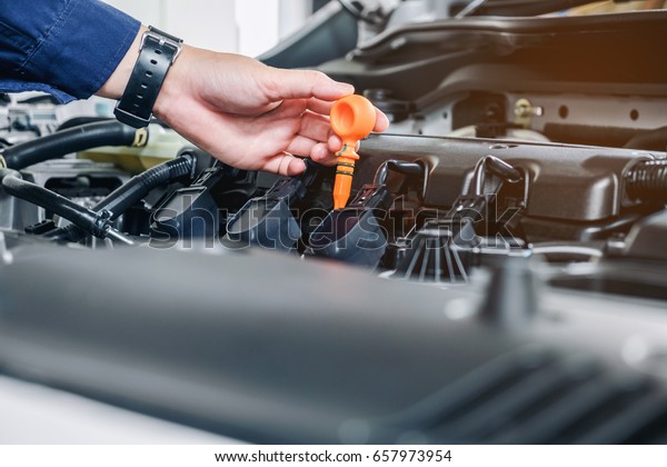 Mechanic\
changing oil mechanic in auto repair\
service.