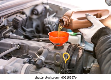 Mechanic Changing Oil In A Car