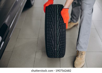 Mechanic Changing Tires In A Car Service