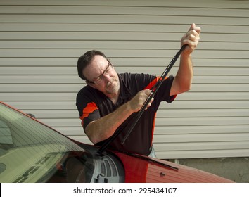 Mechanic Changing Windshield Wiper Blades On A Car.